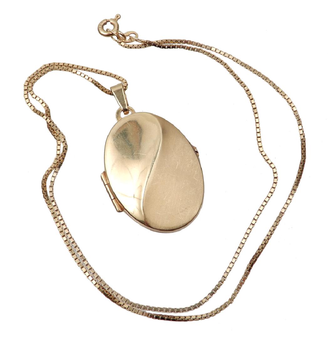 14k gold locket and chain: 14k gold locket and chain, 1 1/8" long x 3/4" wide oval locket with 16" box link chain, holds two photos, locket and chain stamped 14k, 6.7 grams/4.3 dwt