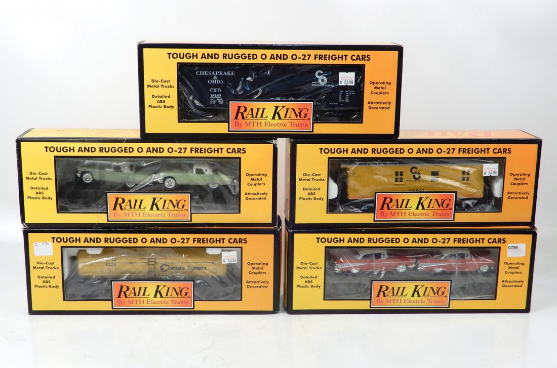 Five MTH Rail King freight cars in boxes: Five MTH Rail King freight cars in boxes, pre-owned, B & O semi-scale box car, yellow semi-scale wood side C & O caboose, gray MTH flat car with Ertl T-birds, yellow Chessie system single dome tank ca