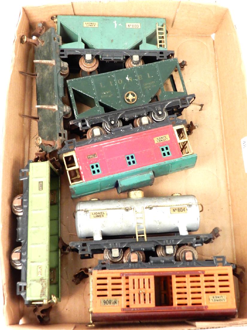 Seven Lionel 800 Series four wheel freight cars: Seven Lionel 800 Series four wheel freight cars, O gauge, two 803 green hopper cars (one light green, one early dark green stamped version), one 831 flat car (no lumber), one 806 orange with brown roo