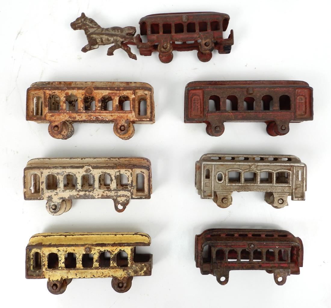 Seven Pre-War cast iron floor toys: Seven Pre-War cast iron floor toys, various manufacturers, unmarked, three are matching white painted coaches approximately 4 1/2" across, three additional coaches 4 1/2" and smaller, horse drawn coac