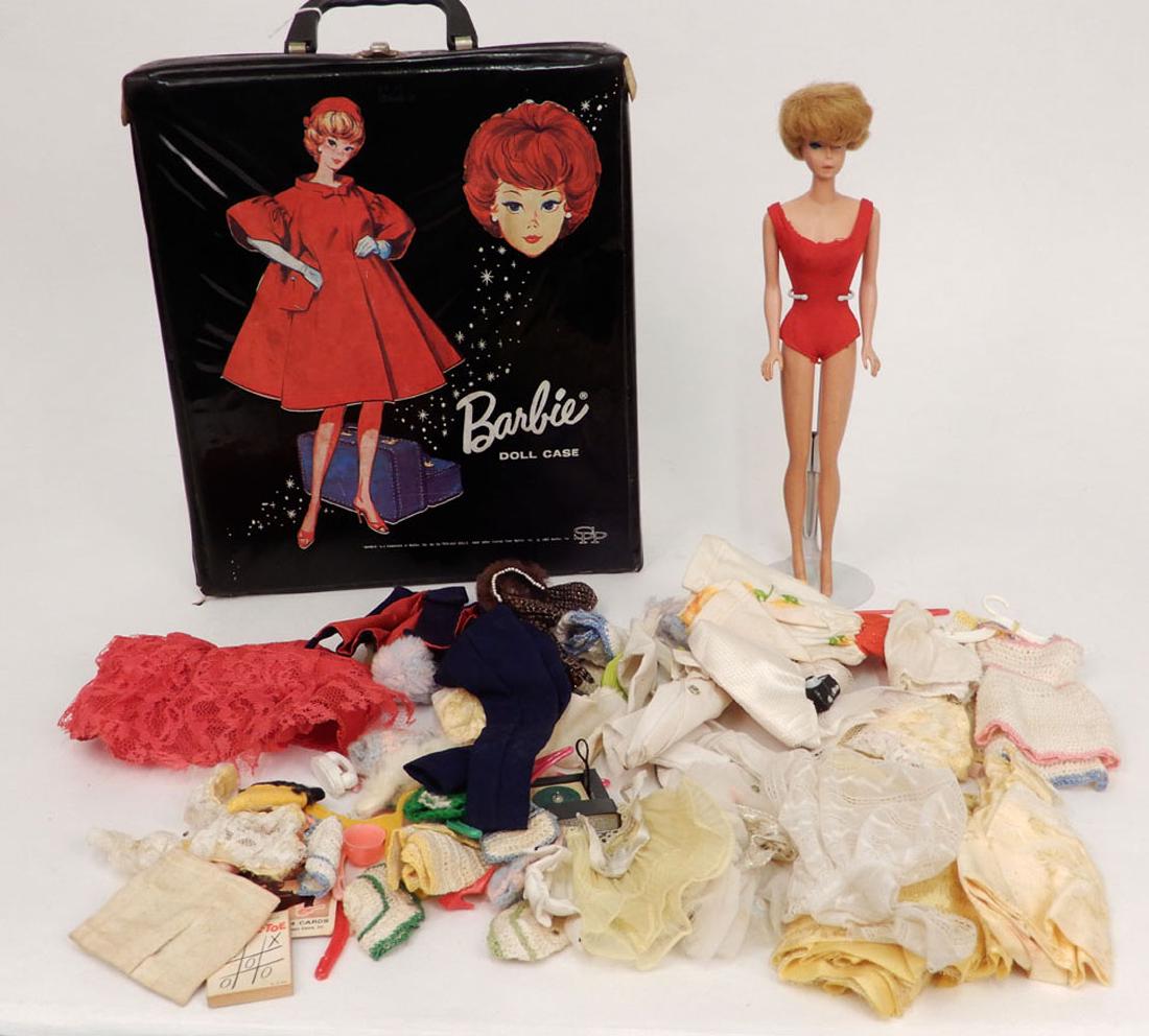 1964 Bubble Cut Barbie doll in carry case with clothes: 1964 Bubble Cut Barbie doll in carry case with clothes, blonde bubble cut Barbie doll, red swimsuit, some tagged clothes, additional clothes, some accessories, case measures 12 1/2" x 10 3/4" x 2 3/4"