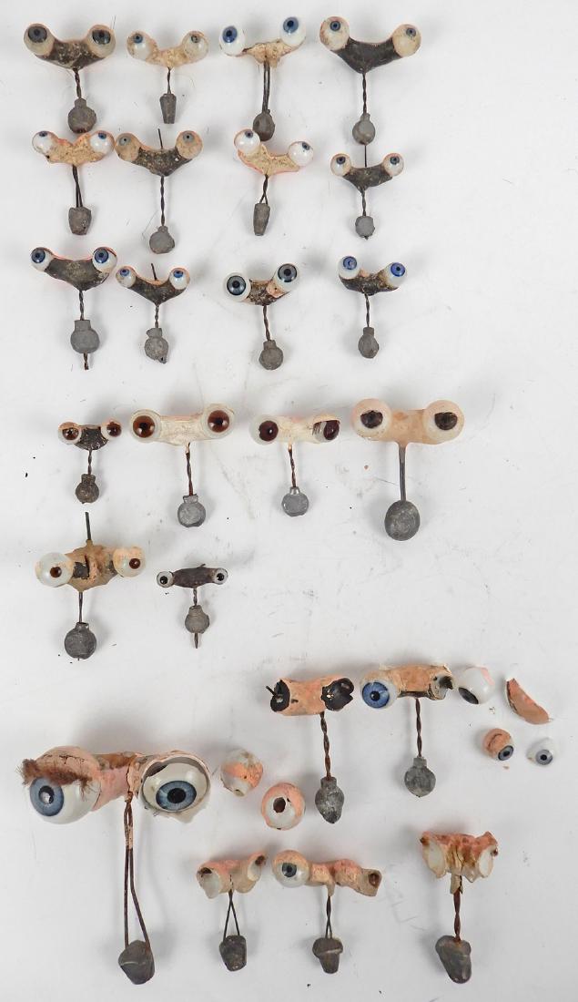 Lot of antique glass doll eyes: Lot of antique glass doll eyes, nineteen assorted size doll eyes with metal rockers, fourteen blue eyes and five brown eyes
