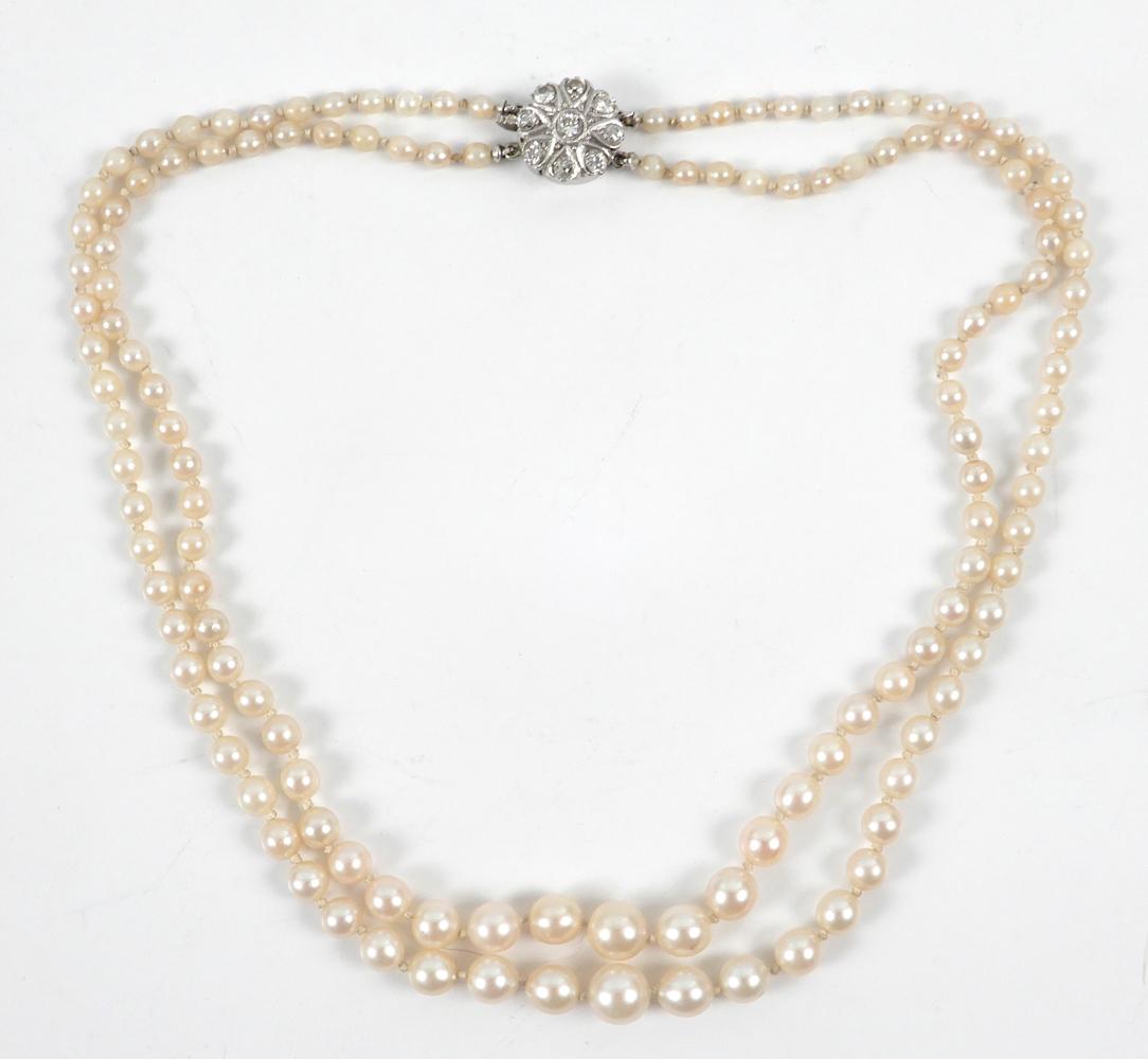 Pearl necklace with diamond clasp: Pearl necklace with diamond clasp, double strand necklace comprised of cultured pearls graduated in size from 8mm to 3mm, individually knotted, 16" long, 14k white gold clasp, 9/16" in diameter, set w