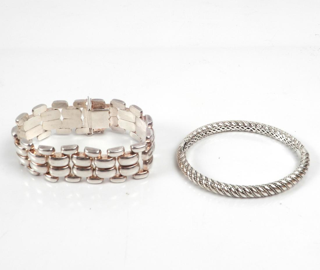 Two modern sterling silver bracelets: Two modern sterling silver bracelets, one hinged bangle bracelet with diagonal beaded design, 1/4" wide, inside dimensions 2 1/4" x 1 7/8", stamped 925 Thailand, weight 28.0 grams; and one link bracel