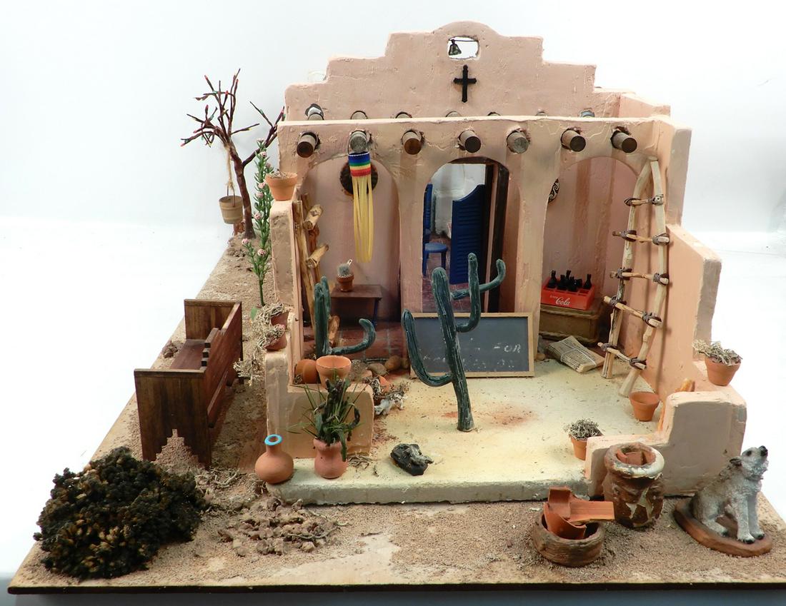 Southwestern adobe diorama: Southwestern adobe diorama, interior with furnishings and kiva fireplace, Christmas lights work on tree with hanging bucket, 11" high x 18" x 28"