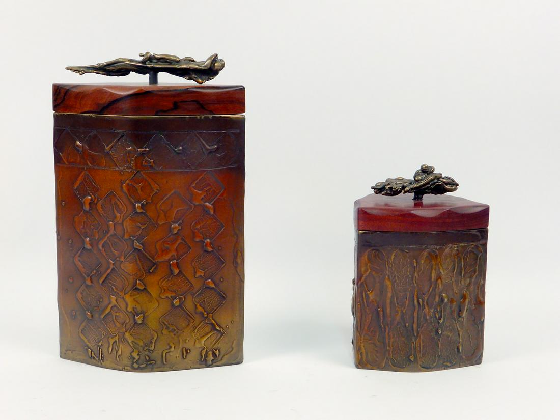 Two Shatsby bronze boxes: Two Shatsby bronze boxes, Chris & Pat Shatsby, two cast bronze pillar style boxes with Vera wood lids and bronze handles, both signed Shatsby on bottom, Edgecomb Potters Maine labels on bottom, 9 1/2"