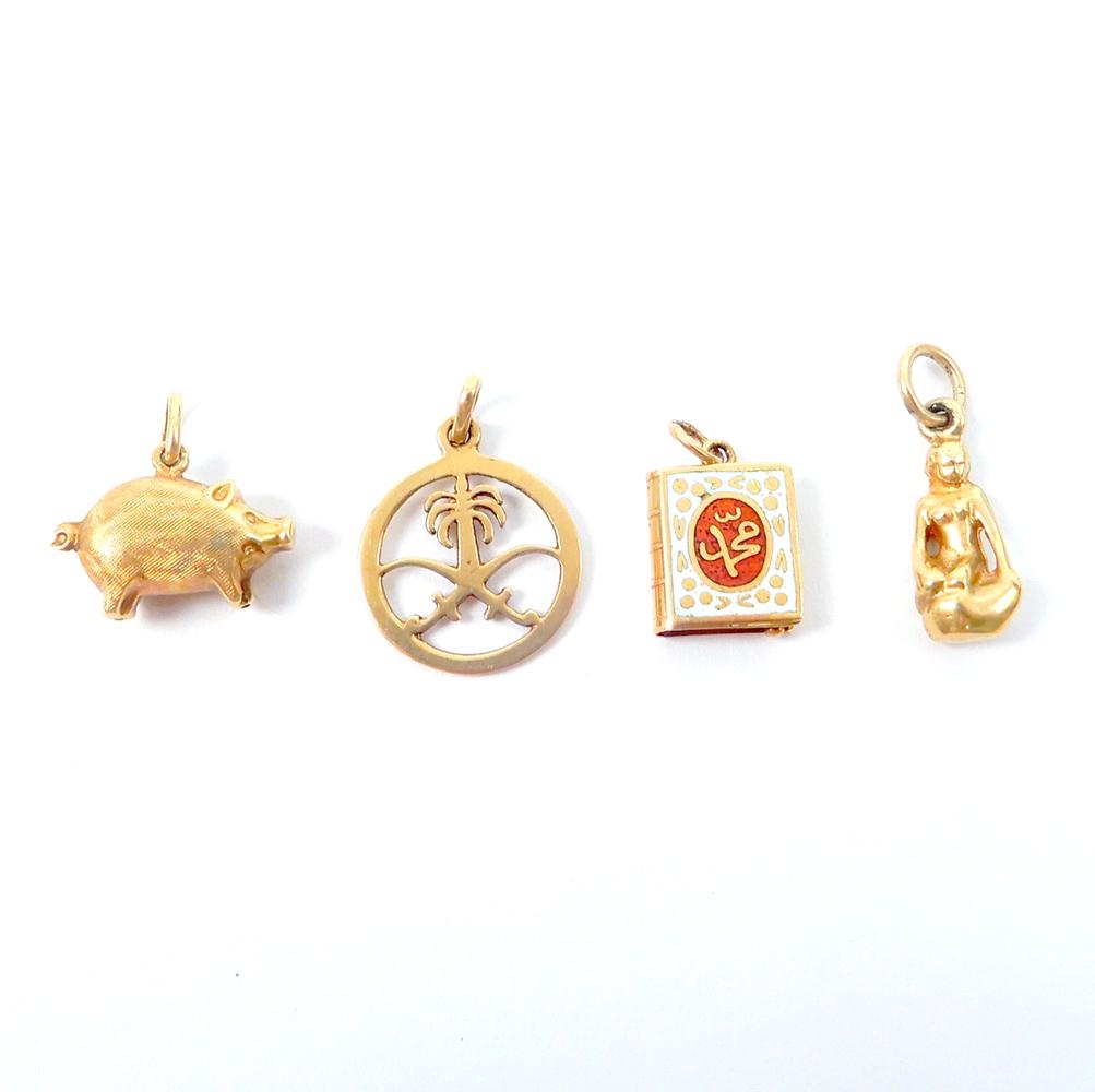Four 14k gold charms: Four 14k gold charms, included are Saudi Arabia emblem, mermaid on rock (Norway), Koran with enameling, and wild boar with brushed gold finish, 1/2" to 3/4" in length, all marked or test 14k, combined