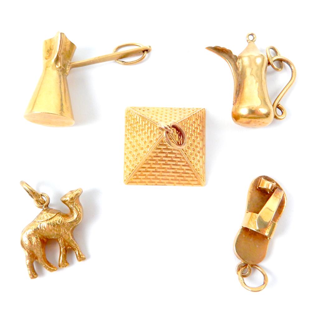 Five 18k gold charms: Five 18k gold charms, included are Egyptian pyramid, sandal, camel, and Turkish coffee pot, all charms marked or test 18k, combined weight 6.2 grams/4.0 dwt