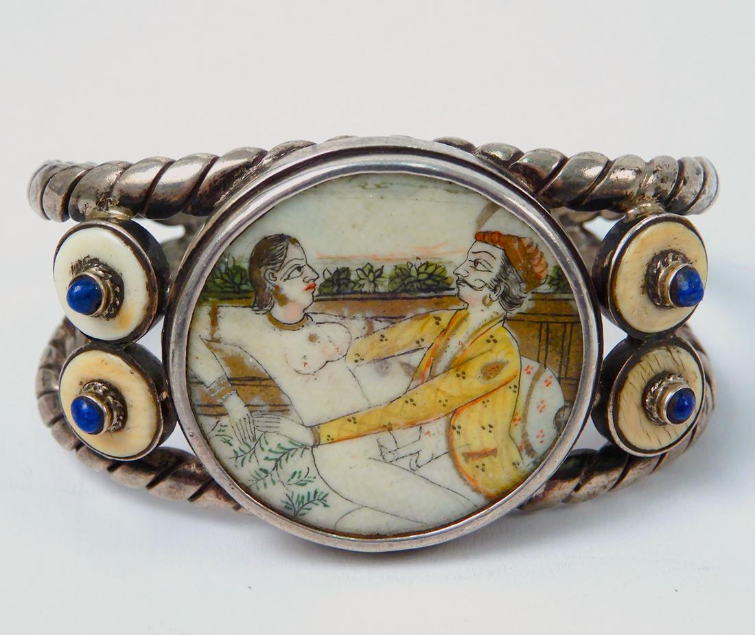Persian 800 silver bracelet with erotic scene: Persian 800 silver bracelet ith erotic scene, cuff bracelet with erotic painting on bone under clear covering, 1 7/16" wide, inside dimensions 2 1/4" x 1 1/2" with 7/8" opening, unmarked, tests 800 si
