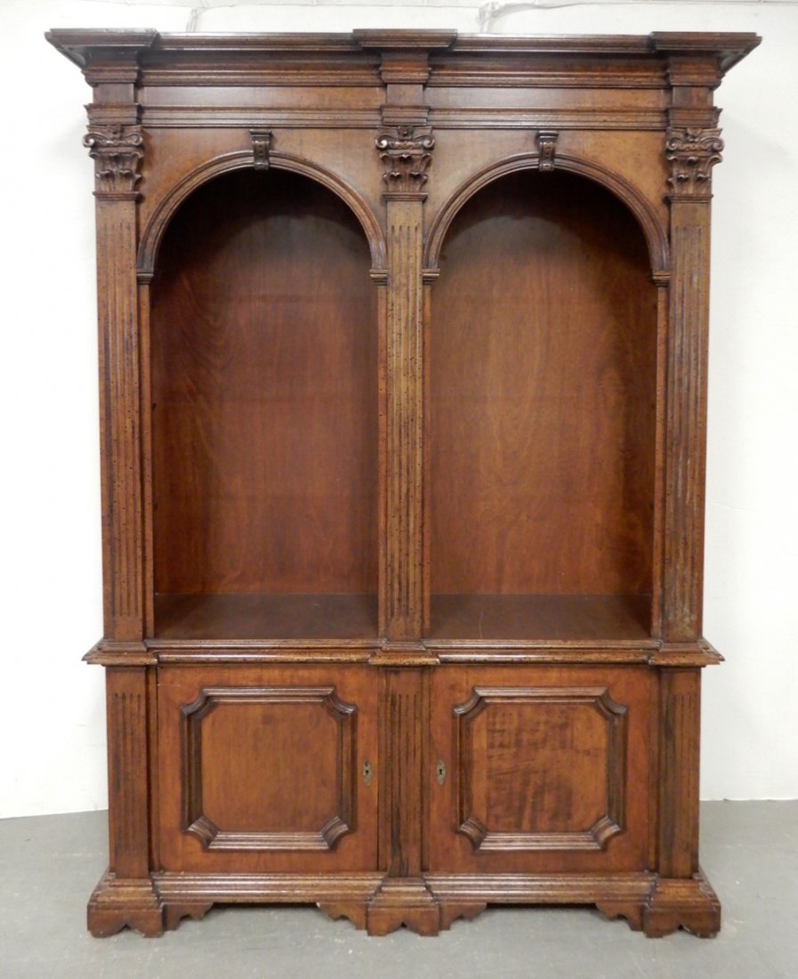 Cherry bookcase: Cherry bookcase, two piece, the top with molded cornice over divided arched bookshelves, a pair of recessed panel doors below, bracket feet, 7'2" x 60" x 16"