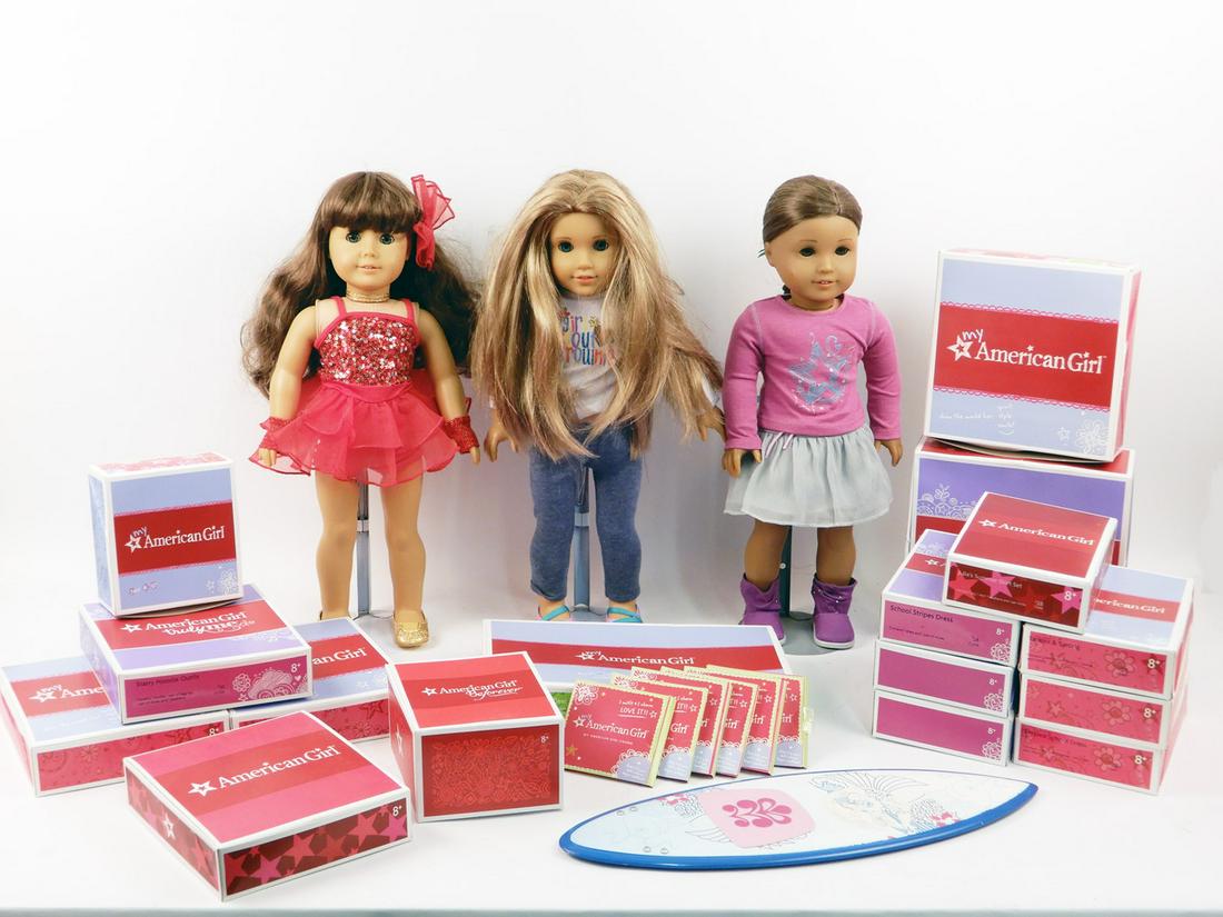 Three American Girl dolls and boxes of outfits and (1 of 9)