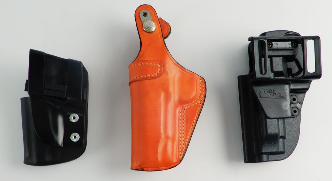 Three belt holders for automatics: Three belt holders for automatics, two are molded plastic (one is Uncle Mike's), and one leather Bianchi #35 Pistol Pocket Colt Commander