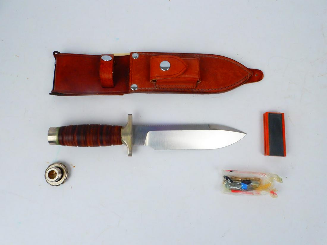 Hackman Finland stainless survival knife: Hackman Finland stainless survival knife, hollow handle, with unopened fishing line, hook and paperwork inside handle, compass and stone in pocket of sheath, 6 7/8" blade with saw teeth, overall 11 7/