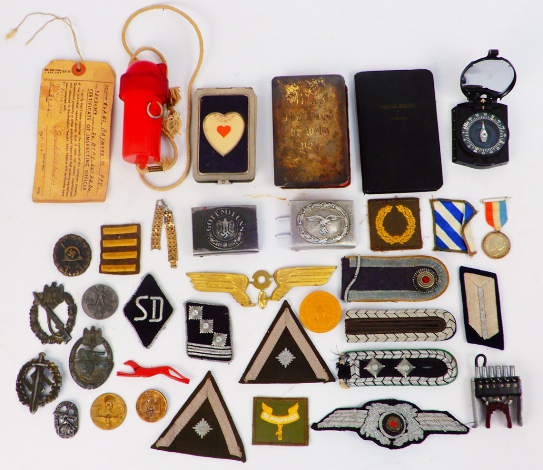 Lot of Nazi pins, patches and belt buckles: Lot of Nazi pins, patches and belt buckles, compass, etc. Also coin with ribbon engraved on verso "Civil Defense Maastricht", "In Remembrance of the first liberated town of Holland" X-mas 1944