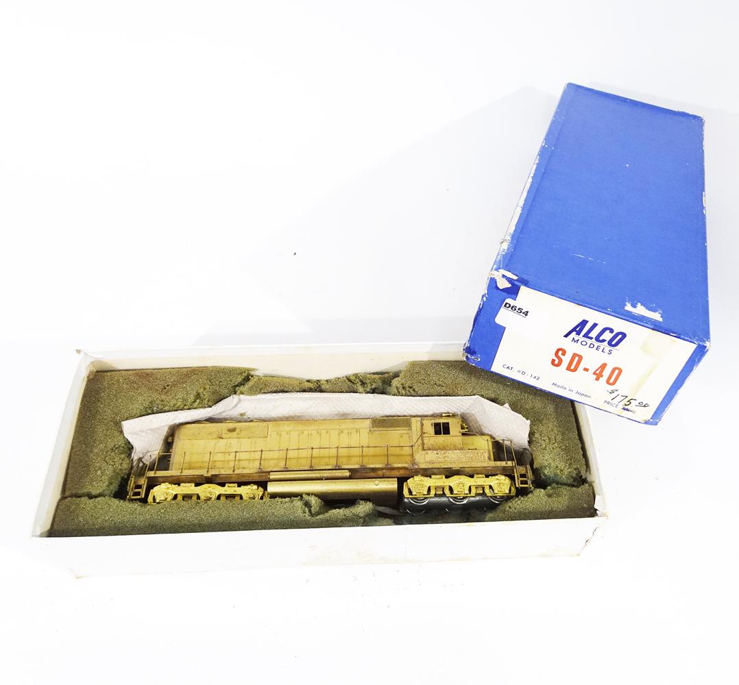 1950's Alco Models SD-40 HO brass diesel engine in: 1950's Alco Models SD-40 HO brass diesel engine in original box. Diesel is pre-owned but has very little residue on wheels. Needs to be cleaned of old foam that has stuck to the engine on one side. Wi