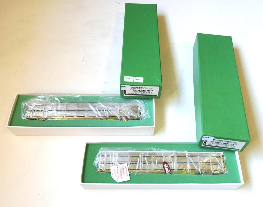 TWO 1990's Overland Models HO gauge brass tri-level: TWO 1990's Overland Models HO gauge brass tri-level auto transports in original boxes. Made by Ajin Precision Models (Korea) and still sealed inside. They have pressed sides with open roofs.