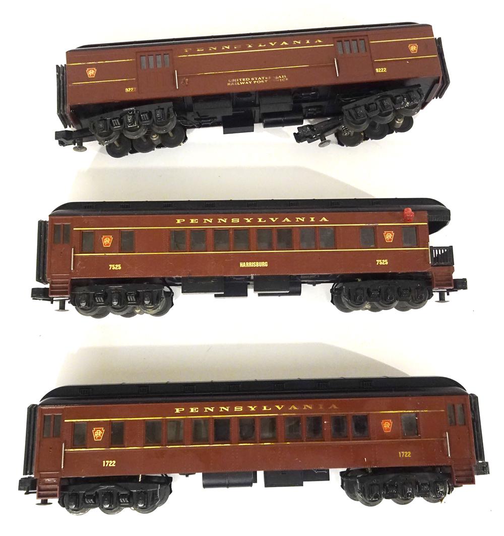 Three 2000's MTH passenger in PRR colors.: Three 2000's MTH passenger in PRR colors. Three cars are a combine, coach and observation car. In PRR colors of brown with black roofs. Combine has truck broken out of chassis. No boxes.
