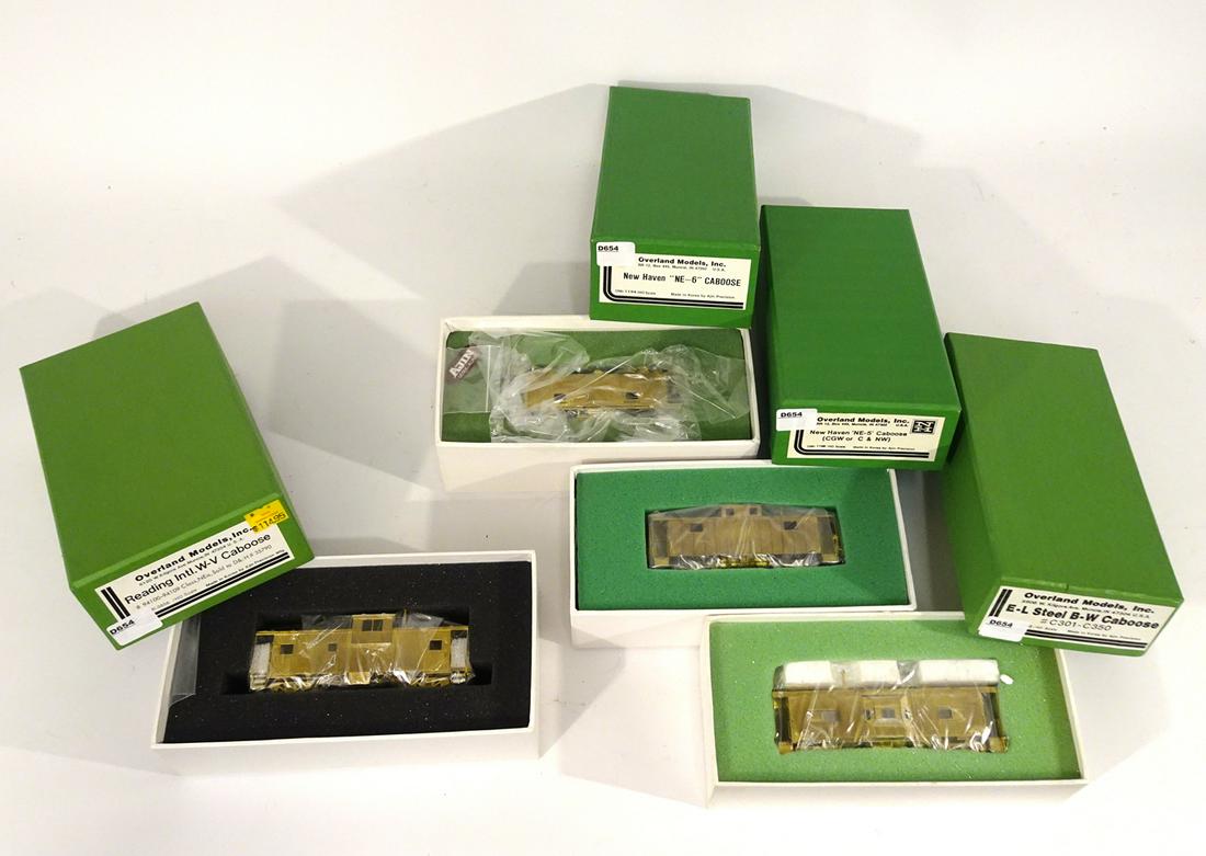 Four 2000's Overland Models brass HO gauge unpainted: Four 2000's Overland Models brass HO gauge unpainted cabooses in original boxes. Cabooses are all unpainted and made by Ajin Precision Models (Korea). The cabooses are a NE-6, a NE-5, an E-L Steel bay