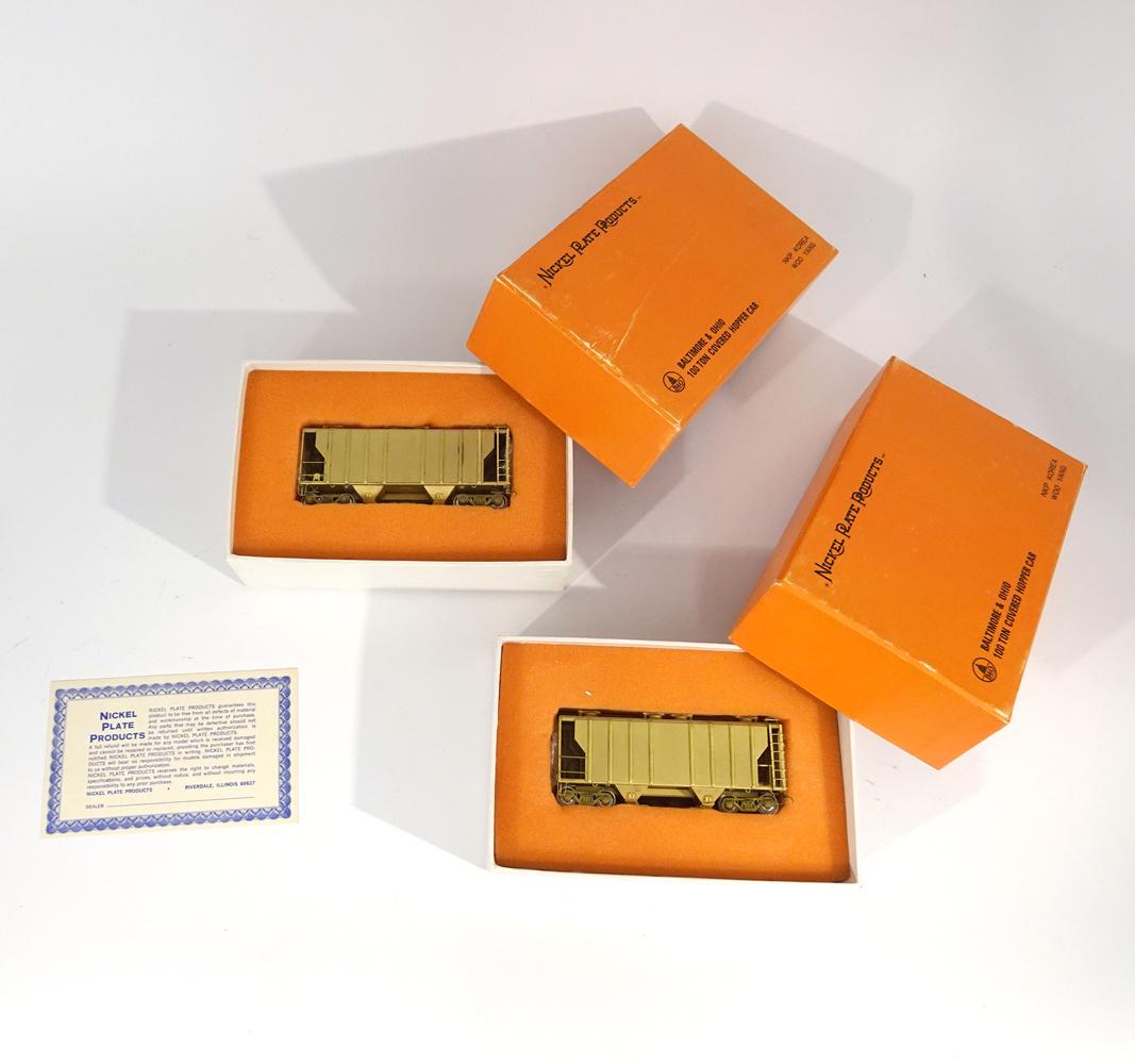Two 1990's unpainted HO gauge Nickel Plate Products 100: Two 1990 unpainted HO gauge Nickel Plate Products 100 ton hoppers in original boxes. Both models are exactly the same and they were made by Woo Yang of Korea. Both original boxes have inserts.