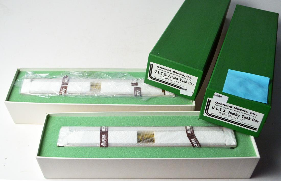 Two early 2000's Overland Models by Ajin (Korea) HO: Two early 2000's Overland Models by Ajin (Korea) HO gauge brass ULTX Jumbo Tank Cars in original boxes. These two brass HO tank cars measure around 12" long. Still sealed in their original boxes.