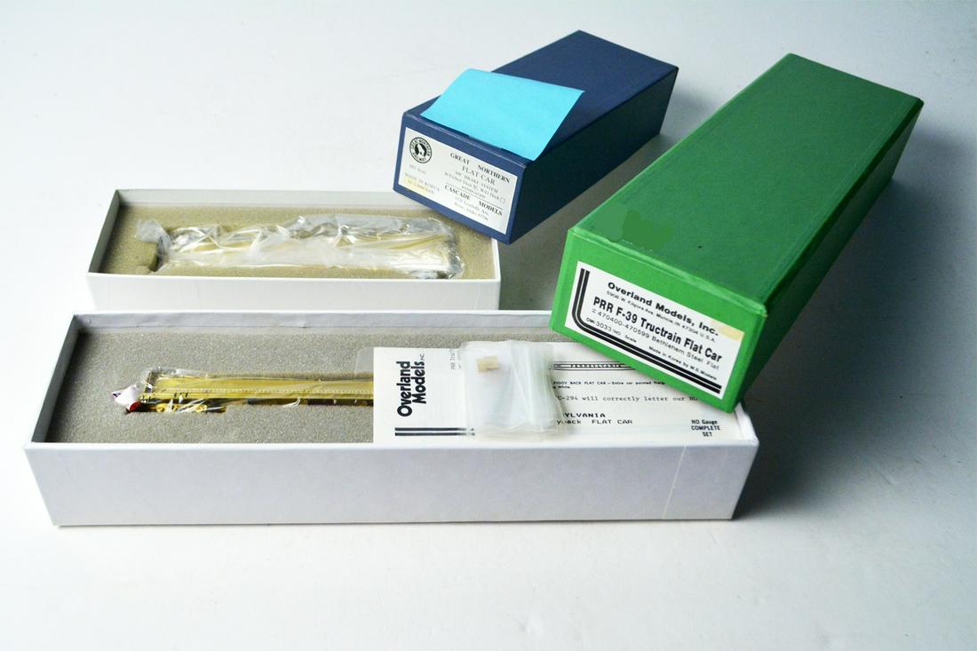 Two late 1990's unpainted brass HO gauge flat cars by: Two late 1990's unpainted brass HO gauge flat cars by Overland Models and Cascade Models in their original boxes. The Cascade Models by Gangsan (Korea) is a little over 7" long with an etched deck. Th