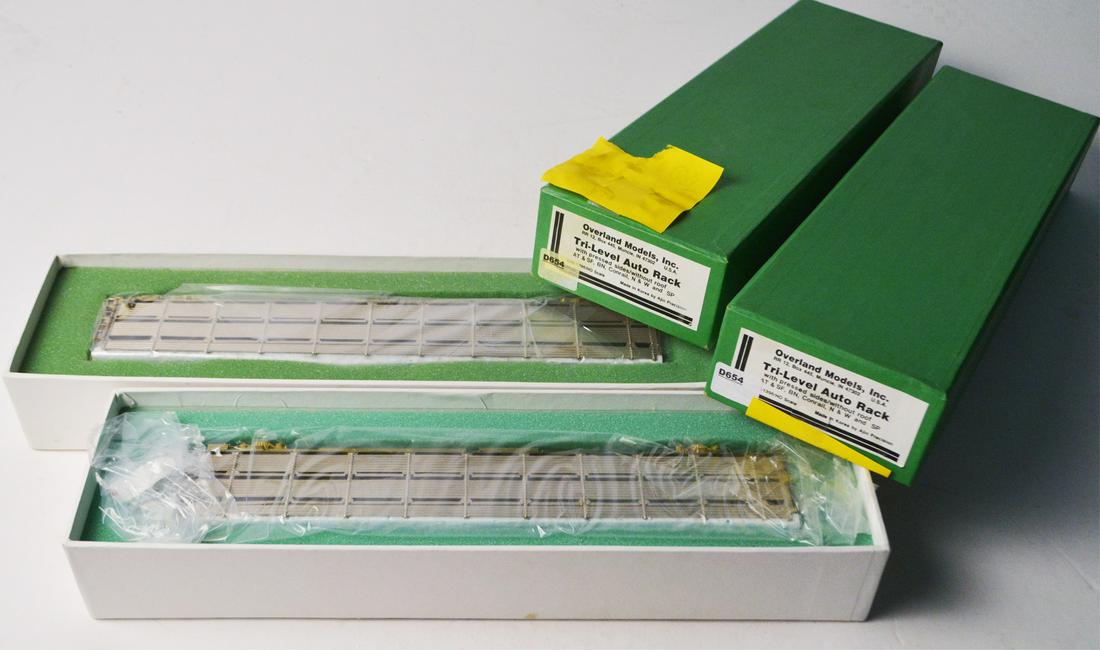 Two 1990's Overland Models by AJIN (Korea) unpainted: Two 1990's Overland Models by AJIN (Korea) unpainted brass HO gauge Tri-Level Auto rack car transport with pressed sides, no roofs in original boxes. Cars measure 12" long. Still wrapped inside their 