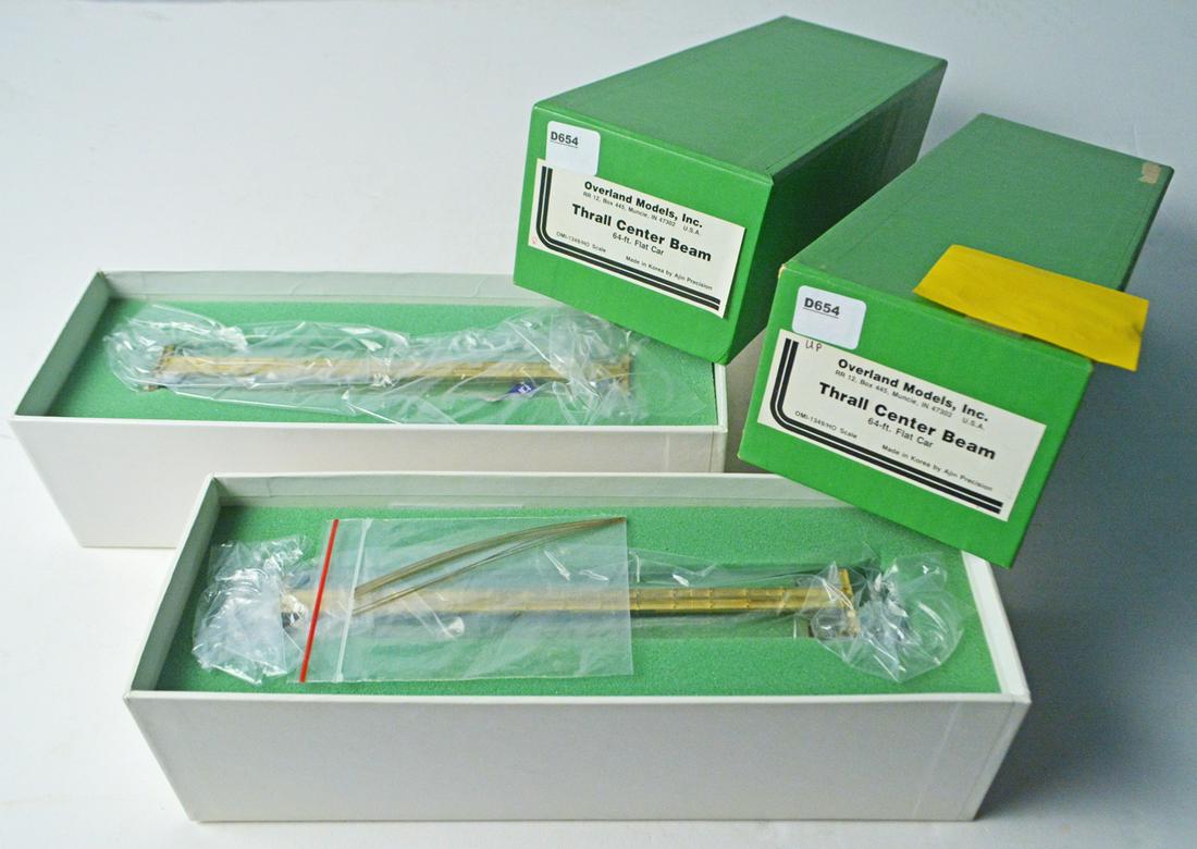 Two 1990's Overland Models by AJIN (Korea) unpainted: Two 1990's Overland Models by AJIN (Korea) unpainted brass HO gauge 64ft Thrall Center Beam flatcars in their original boxes. Both cars still wrapped in factory plastic. They measure 9" long.