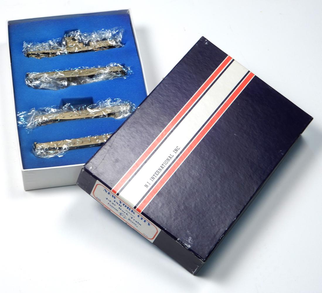 1980's NJ Custom Brass (Korea) unpainted brass HO gauge: 1980's NJ Custom Brass (Korea) unpainted brass HO gauge 4-car New York City Subway System work train in original box. Set includes a powered MOW unit, two low side gondolas/flat cars and a gondola/fla