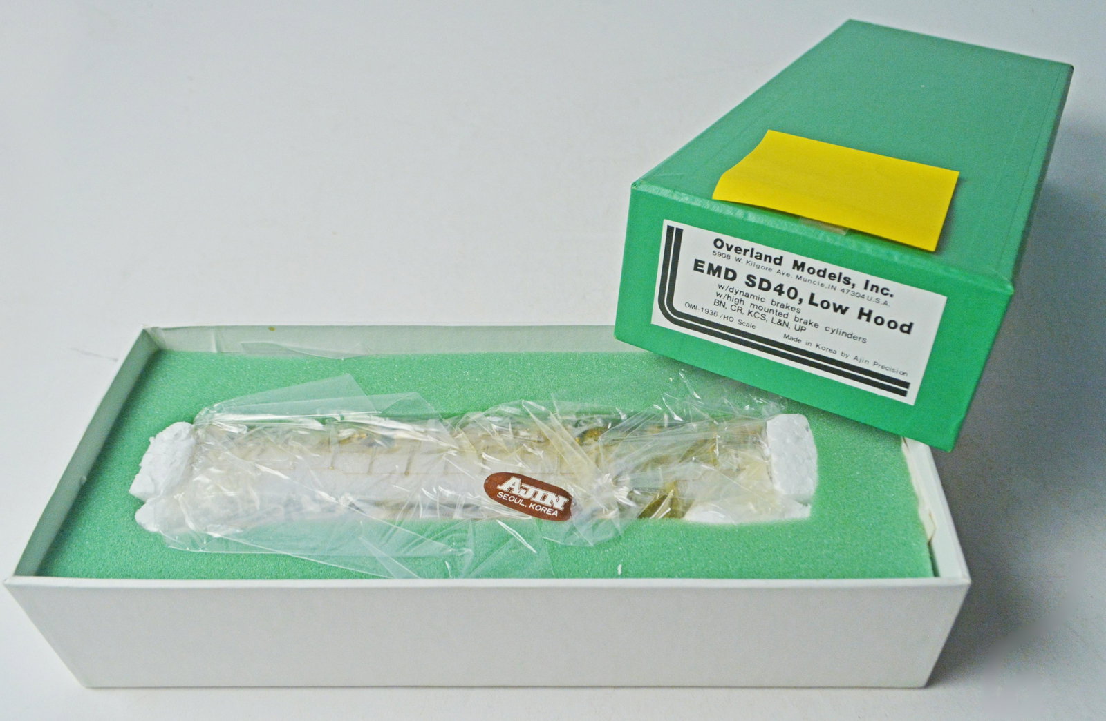 1990's Overland Models by AJIN (Korea) unpainted brass: 1990's Overland Models by AJIN (Korea) unpainted brass HO gauge EMD SD-40 low hood diesel engine in original box. Engine measures about 9" long. Still in factory wrap.