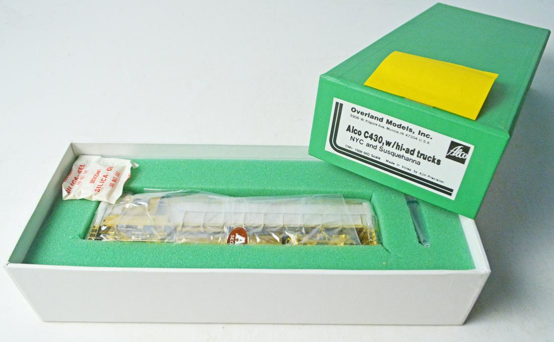 1990's Overland Models by AJIN (Korea) unpainted brass: 1990's Overland Models by AJIN (Korea) unpainted brass HO gauge ALCO C430 with HI-AD trucks in original box. Engine measures about 8" long. Still wrapped in factory plastic.