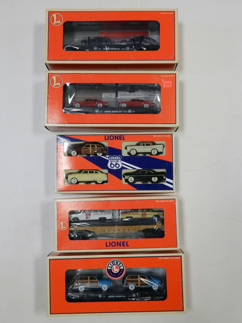 Four 2000's Lionel O gauge flat cars with auto loads: Four 2000's Lionel O gauge flat cars with auto loads and a pack of Route 66 1950's auto all in original boxes. The lot consists of #36000 Lionel Route 66 flat car with two 1950's red sedans, #17537 Li
