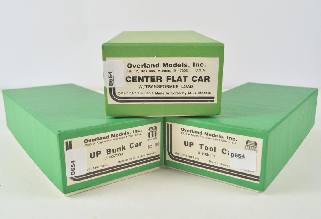 Three 1990's Overland Models by AJIN (Korea) unpainted: Three 1990's Overland Models by AJIN (Korea) unpainted brass HO gauge MOW freight cars, bunk car, tool car and depressed center flat car with load in original boxes. All three still factory wrapped.