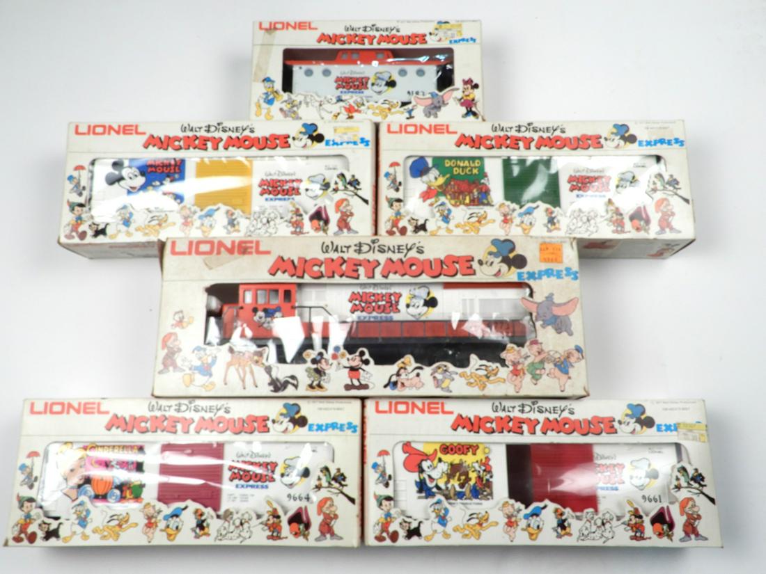1970's Mickey Mouse diesel engine #8773 and four Mickey: 1970's Mickey Mouse diesel engine #8773 and four Mickey Mouse box cars and a caboose all in original boxes. The four box cars are #9662 Donald Duck box car, #9661 Goofy box car, #9664 Cinderella box c