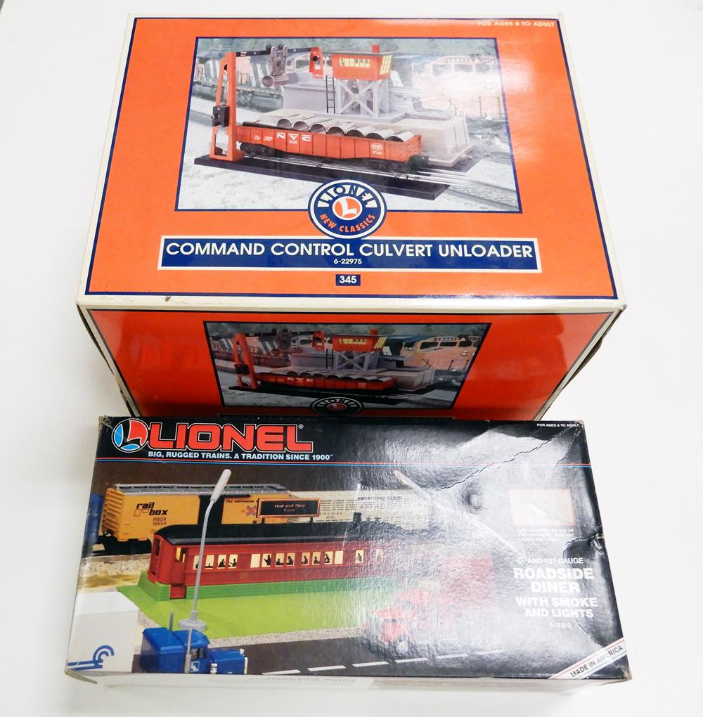 Two 1990's-2000's Lionel O gauge operating platform: Two 1990's-2000's Lionel O gauge Operating platform accessories in original boxes. #12808 Roadside Diner with lights and smoke, and #22975 replica of post-war 345 Culvert Unloader. This unit has comma