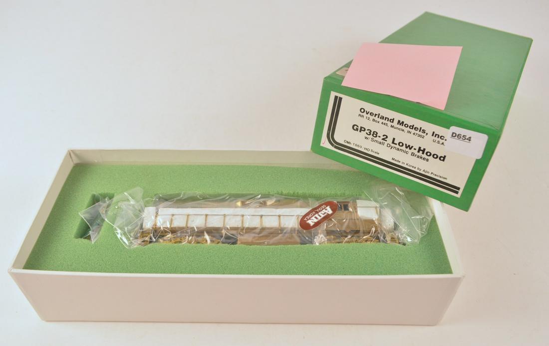1990's Overland Models by AJIN (Korea) unpainted brass: 1990's Overland Models by AJIN (Korea) unpainted brass HO gauge GP-38-2 low hood diesel with small dynamic brakes in original box. Engine measures 8" long. Still factory wrapped.