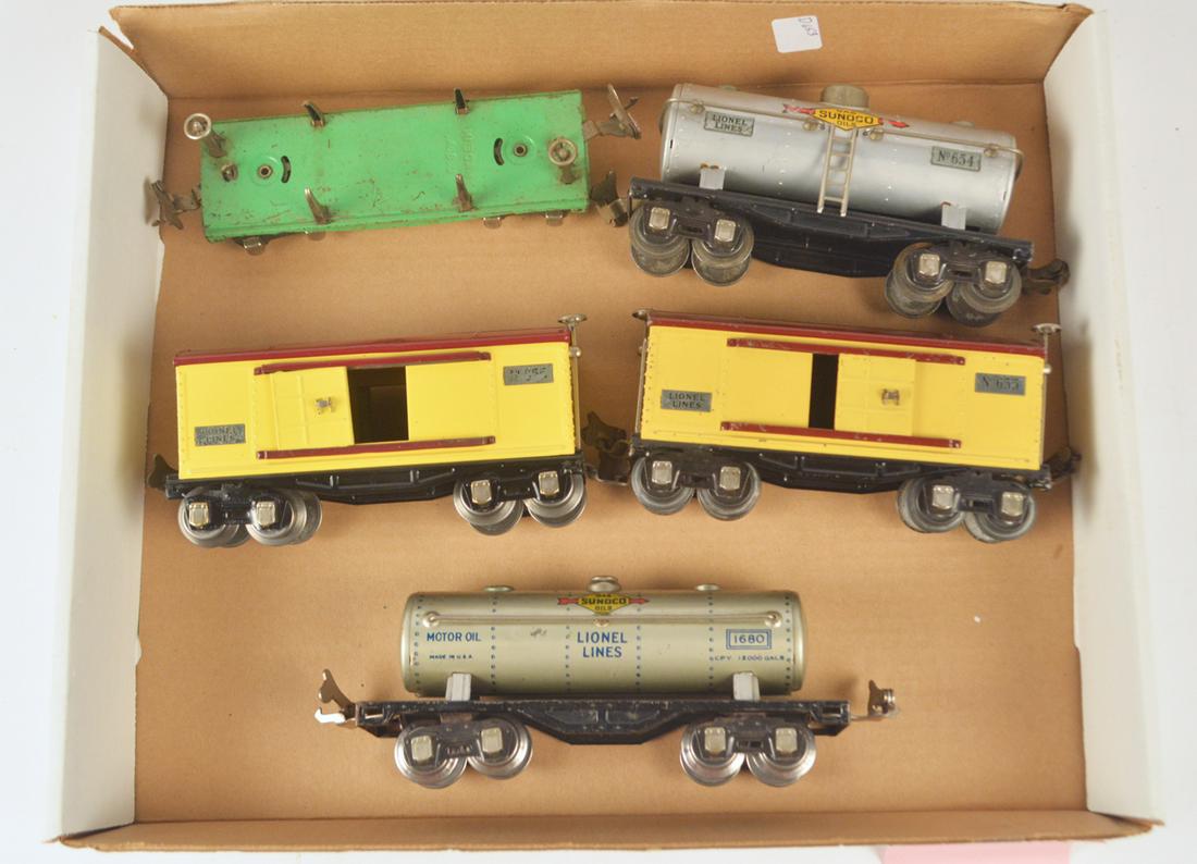 Four 1930's 600 series freight cars and one 1930's: Four 1930's 600 series freight cars and one 1930's #1680 tank car. There are two #655 box cars, one of which may have been repainted, a #654 Sunoco tank car, a #651 green log car (no logs) and the #16