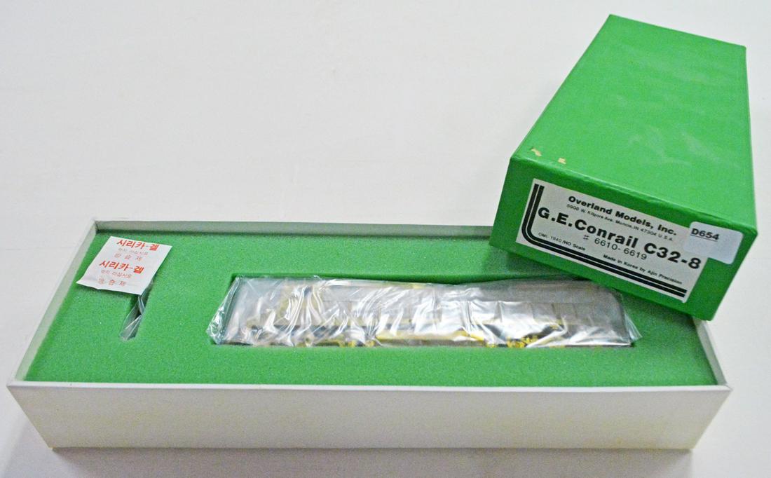 1990's Overland Models by AJIN (Korea) unpainted brass: 1990's Overland Models by AJIN (Korea) unpainted brass HO gauge GE Conrail C32 8 diesel engine in original box. Engine is over 9" long. Still wrapped in factory plastic.