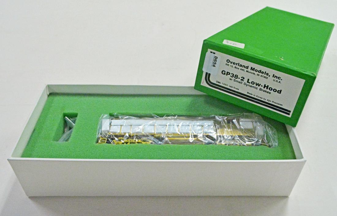 1990's Overland Models by AJIN (Korea) unpainted brass: 1990's Overland Models by AJIN (Korea) unpainted brass HO gauge GP-38-2 low hood diesel engine with small dynamic brakes in original box. Engine is still wrapped in factory plastic.