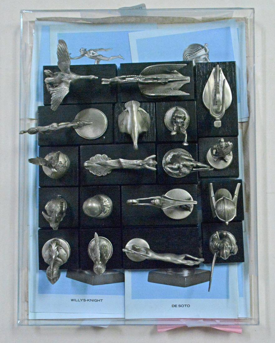 Eighteen Franklin Mint Historical American car hood: Eighteen Franklin Mint Historical American car hood ornaments with paperwork and a Franklin Mint display stand for the hood ornaments. These hood ornaments are made of pewter and have a wood base, 198