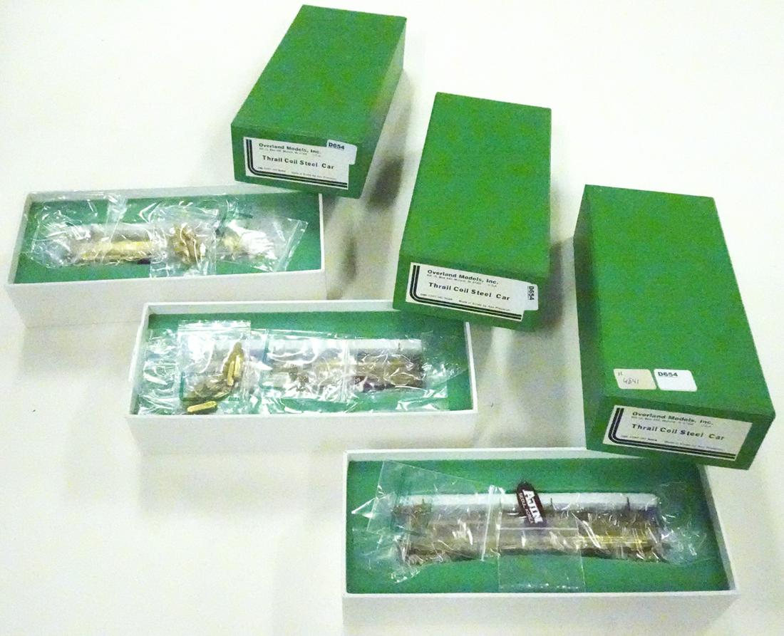 Three 1990's Overland Models by AJIN (Korea) unpainted: Three 1990's Overland Models by AJIN (Korea) unpainted brass HO gauge Thrall Coil Steel cars in original boxes. All three cars still wrapped in factory plastic.