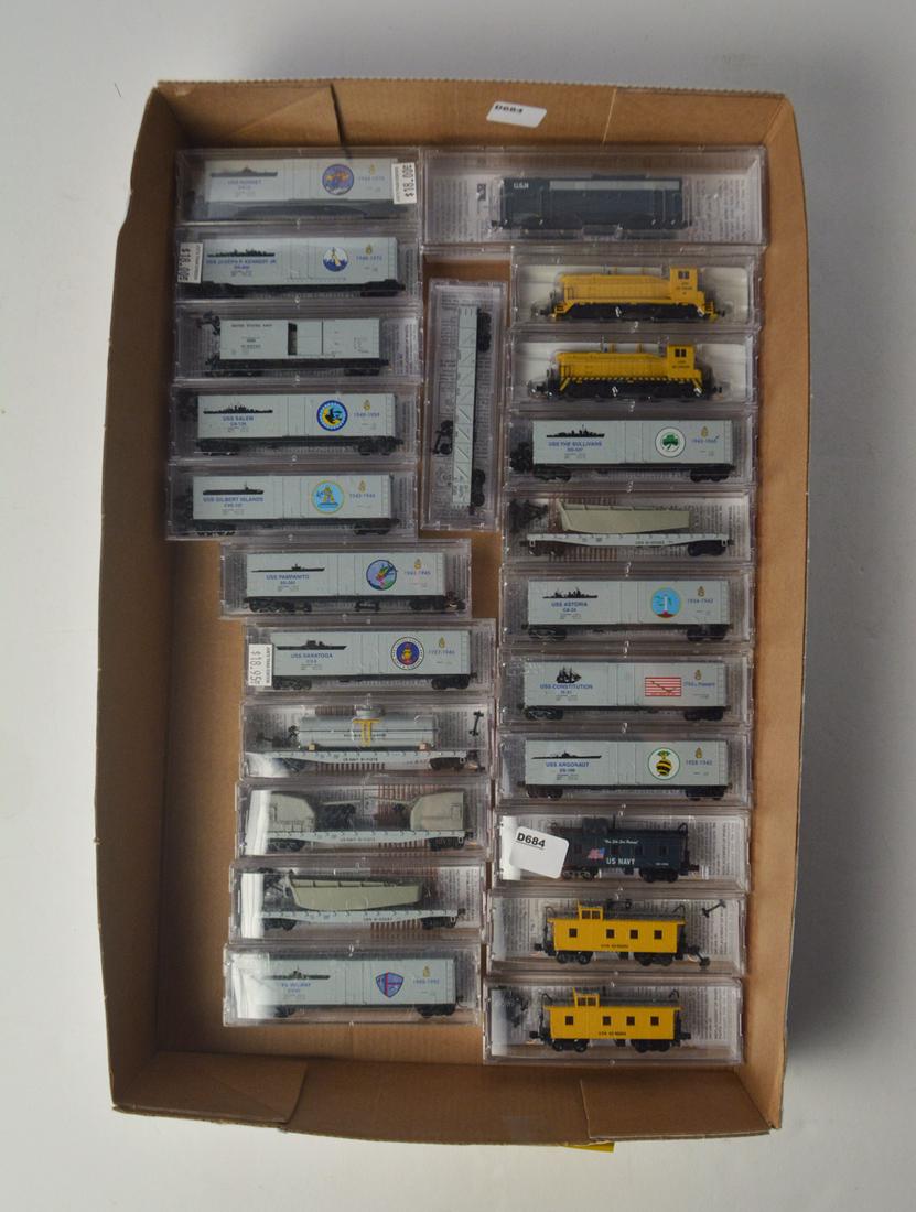 Twenty-three 2000's Micro Trains N scale US Navy: Twenty-three 2000's Micro Trains N scale US Navy commemorative freight cars and engines in original plastic cases. There are three engines 2 yellow SW switchers and a powered USN "B" unit, three USN c