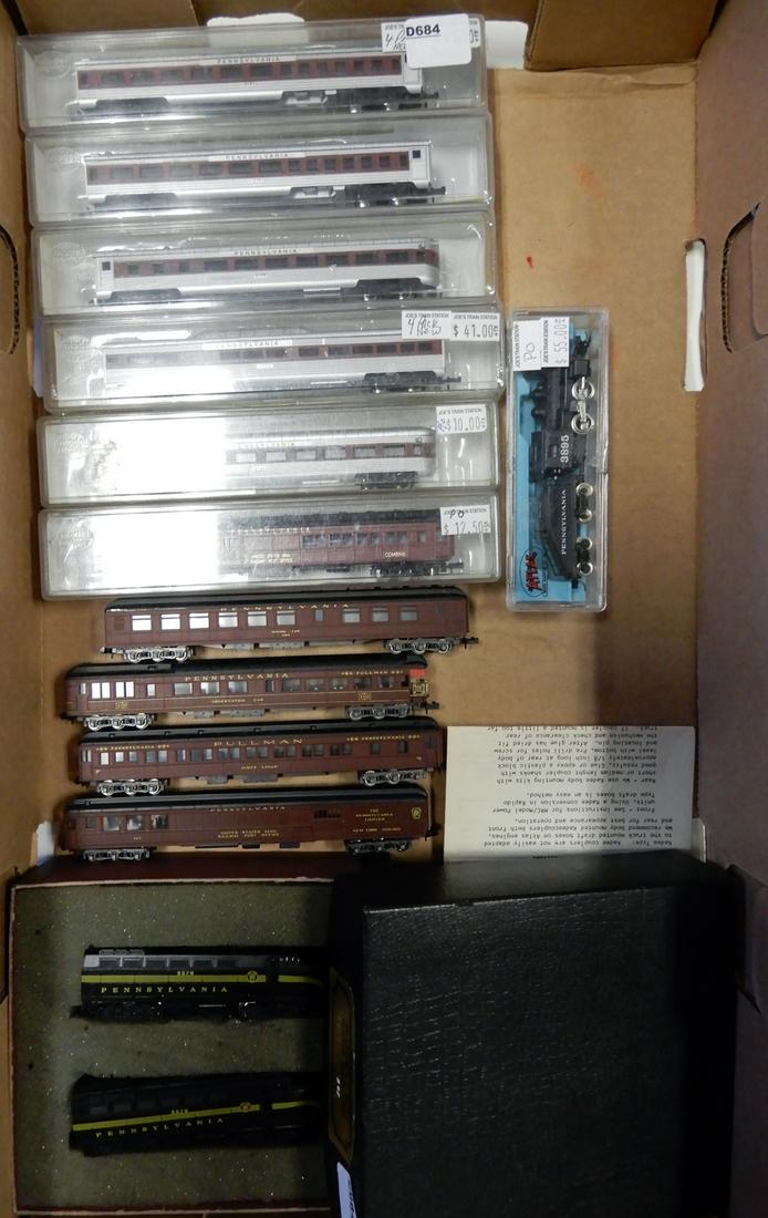 Thirteen piece 1980's-1990's N scale PRR passenger cars: Thirteen piece 1980's-1990's N scale PRR passenger cars and engines most in original boxes. They are all decorated for the PRR. The engines are AK-SAR BEN custom decorated PRR black Shark nose A-A uni