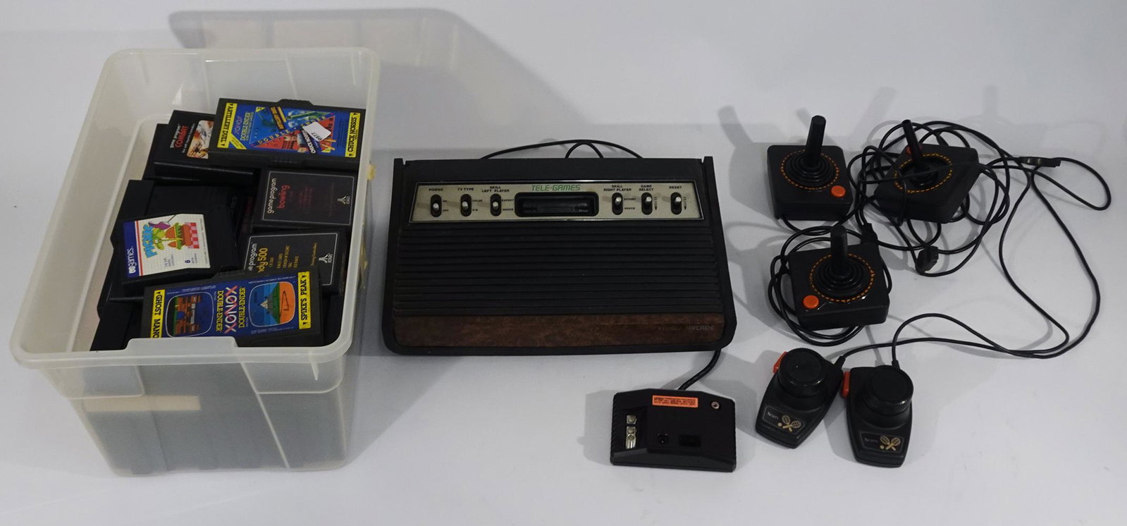 Atari Tele-games console and Atari game cartridges: Atari Tele-games console and Atari game cartridges, sixty-nine game cartridges, with three joysticks and two controllers.