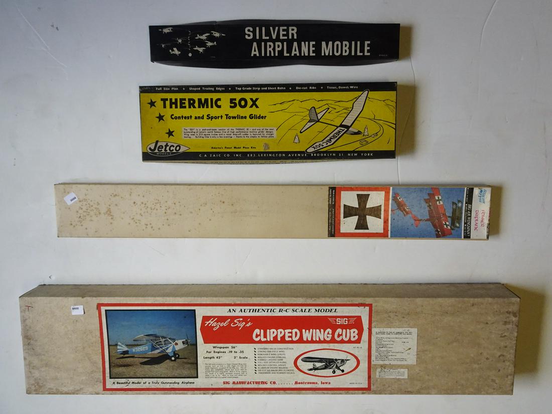 Four 1950-1960's wood and metal airplane models in: Four 1950-1960's wood and metal airplane models in original boxes. The lot consists of a Sig's Clipped wing Cub wood and metal airplane with a wingspan of 56" and is 42" long, a wood and fabric Red Ba