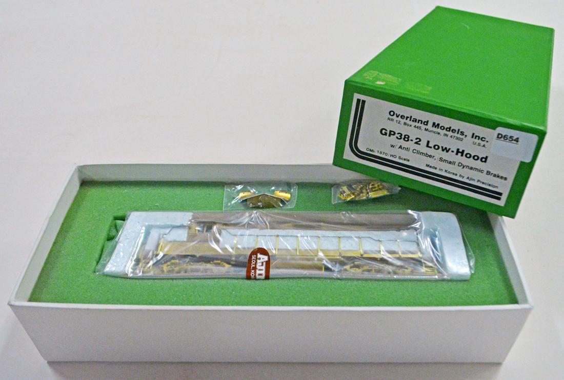 1990's Overland Models by AJIN (Korea) unpainted brass: 1990's Overland Models by AJIN (Korea) unpainted brass HO gauge GP-38-2 low hood diesel engine with small dynamic brakes in original box. Still wrapped in original factory plastic.
