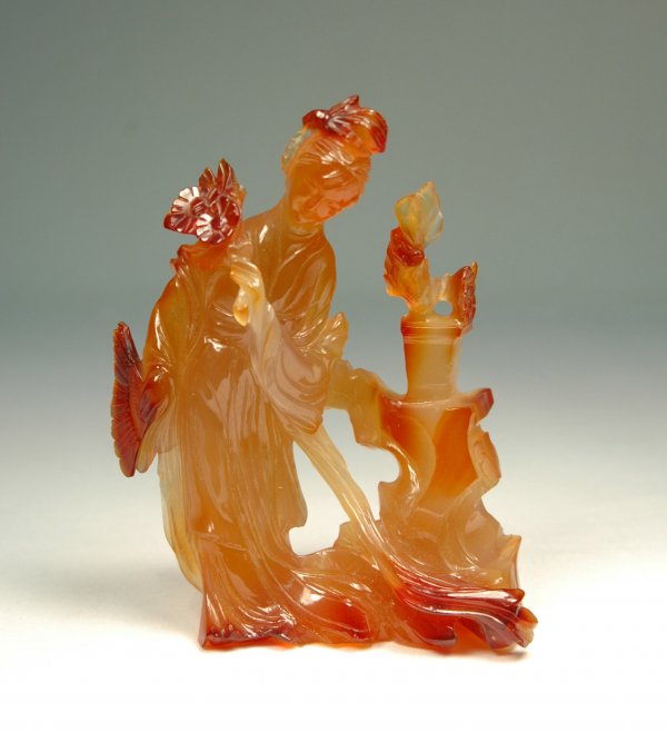 Carved carnelian figure, woman with fan and flowers: Carved carnelian figure, woman with fan and flowers, 19th C., 5" x 4" x 2", very small chip on back near bottom