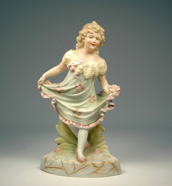 Heubach bisque figure of a girl with intaglio eyes.: Heubach bisque figure of a girl with intaglio eyes. Stamped on back "Made in Germany" and impressed with Heubach mark, early 20th C., measures 11 1/2" high x 6 3/4". No visible defects