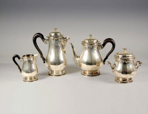 Four piece 800 silver tea and coffee service, flow: Four piece 800 silver tea and coffee service, flower finials, ebonized wood handles. Marked 800 on bottom, no makers mark. Coffeepot 24 av ozs tw & 9" high, teapot 25.8 av oz tw & 8", covered sugar 18