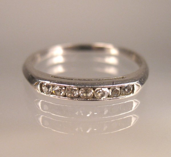 Platinum and diamond wedding band set with seven d: Platinum and diamond wedding band set with seven diamonds measuring approximately 2 points each, size 5 1/2, C. 1920, marked platinum, weight 1.5 dwt/2.4 grams, no visible defects