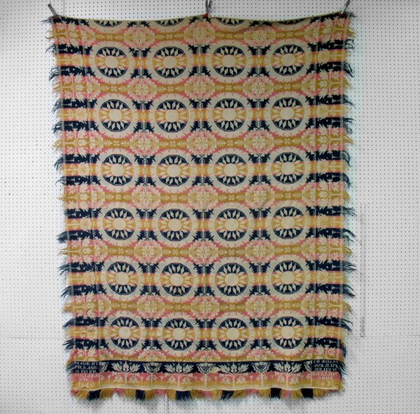 Tricolor jacquard coverlet, "Made by PH. Rass. Wel: Tricolor jacquard coverlet, "Made by PH. Rass. Weller, Millersburg 1849". Measures 68" x 96". Areas of loss, splits, some repairs.